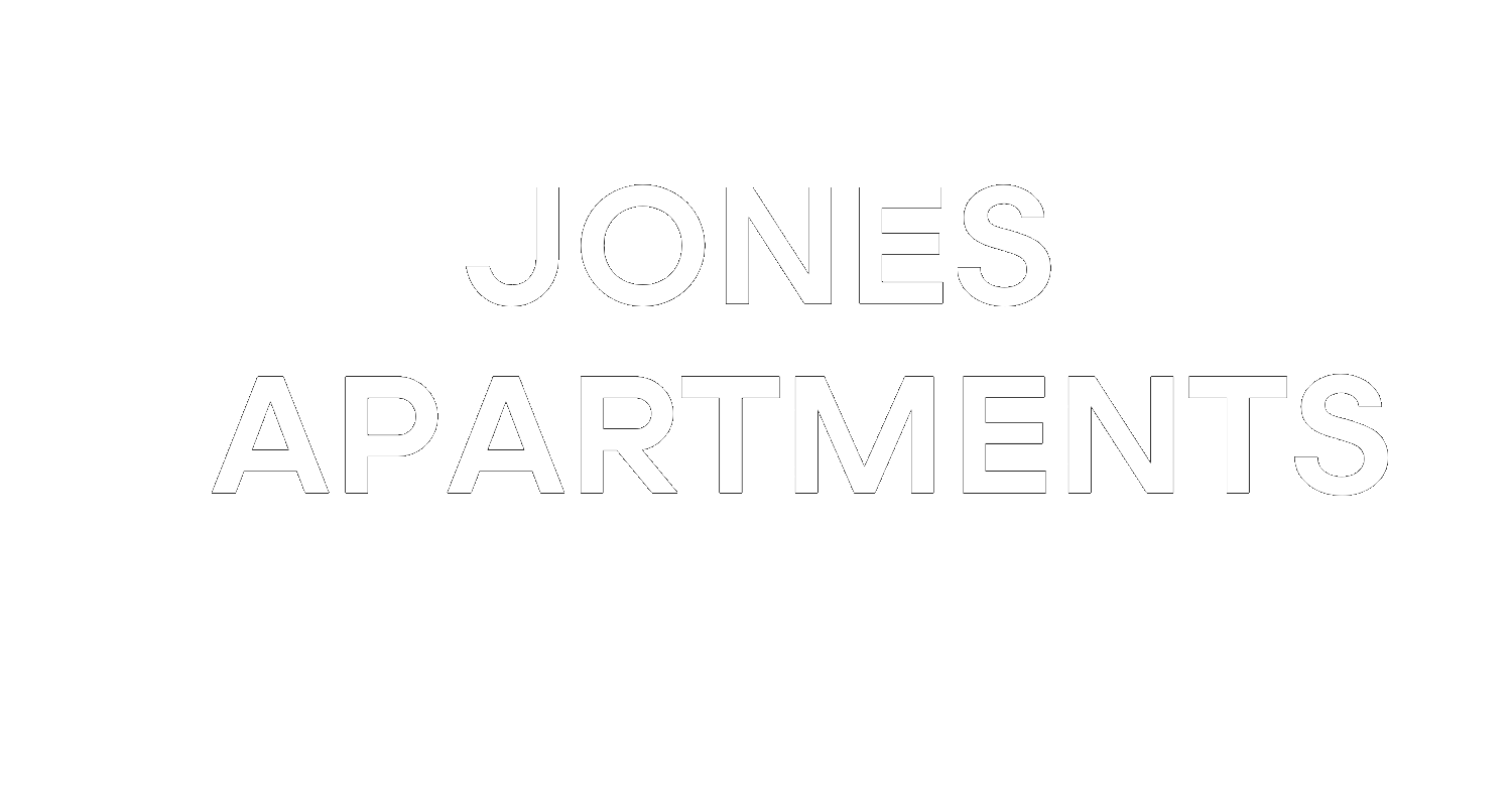 A sign that says "Jones Apartments" in white text on a green background.